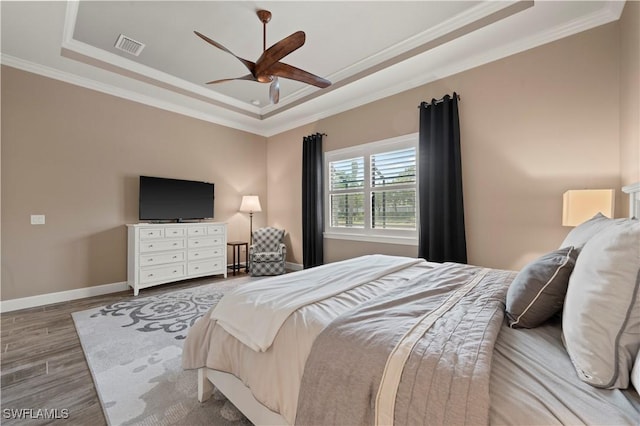 12917 Hadley Ct, Fort Myers, FL 33913 - bedroom featuring a tray ceiling, ornamental molding, wood finished floors, baseboards, and a ceiling fan