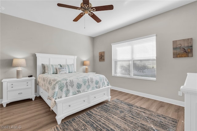 bedroom featuring ceiling fan and dark hardwood / wood-style floors