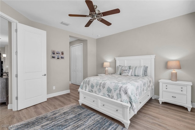 bedroom with ceiling fan, a closet, and light hardwood / wood-style floors