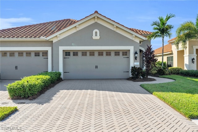 mediterranean / spanish home with a front yard and a garage