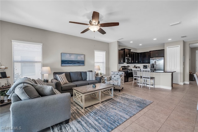 tiled living room with ceiling fan