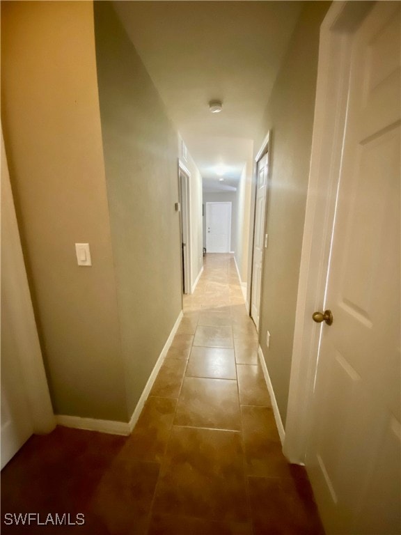 hallway with tile patterned floors