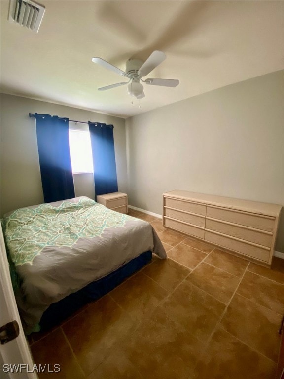 tiled bedroom with ceiling fan