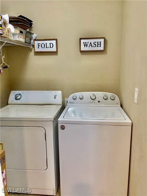 clothes washing area with washing machine and clothes dryer