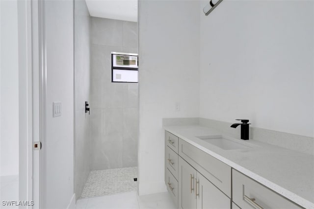 bathroom with vanity and tiled shower