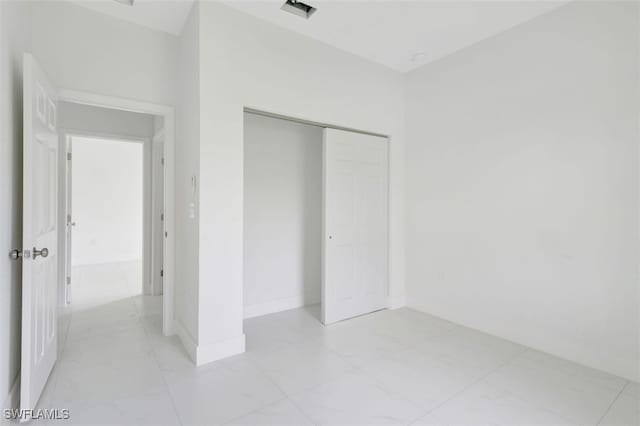 unfurnished bedroom with a closet