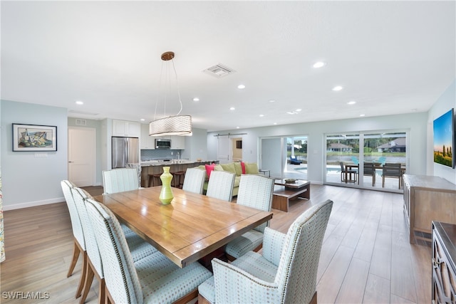 dining area with light hardwood / wood-style flooring