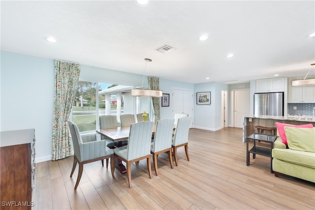 dining area with light hardwood / wood-style floors