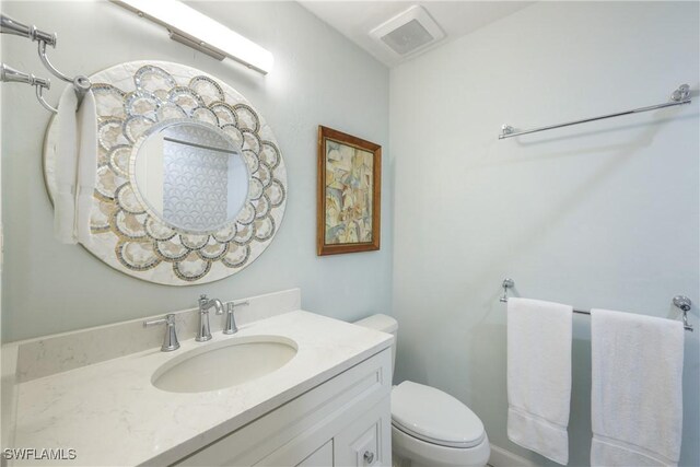 bathroom featuring vanity and toilet