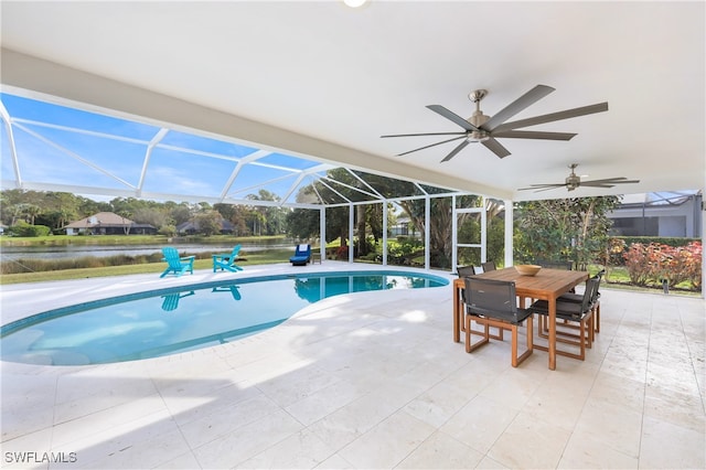 view of pool featuring a water view, a patio, glass enclosure, and ceiling fan