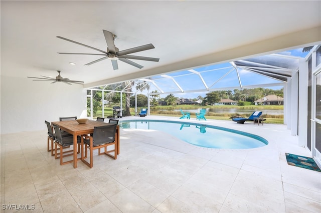 view of swimming pool with ceiling fan, a lanai, and a patio area