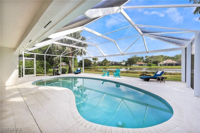 view of swimming pool featuring a water view, glass enclosure, and a patio area