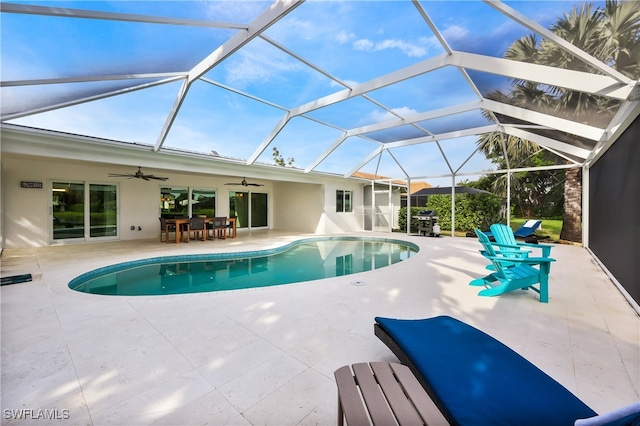 view of pool with a lanai, a patio, and ceiling fan