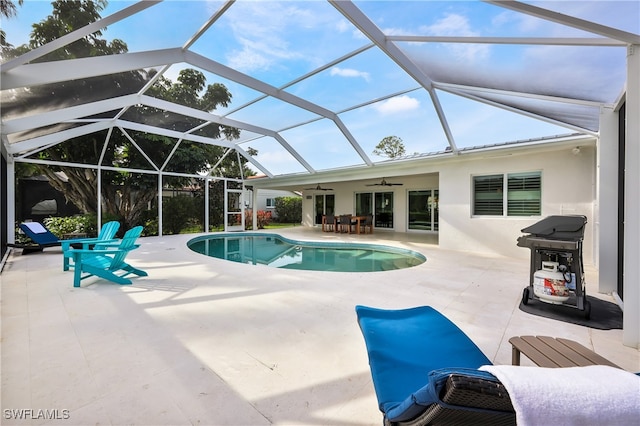 view of swimming pool featuring a patio, area for grilling, a lanai, and ceiling fan