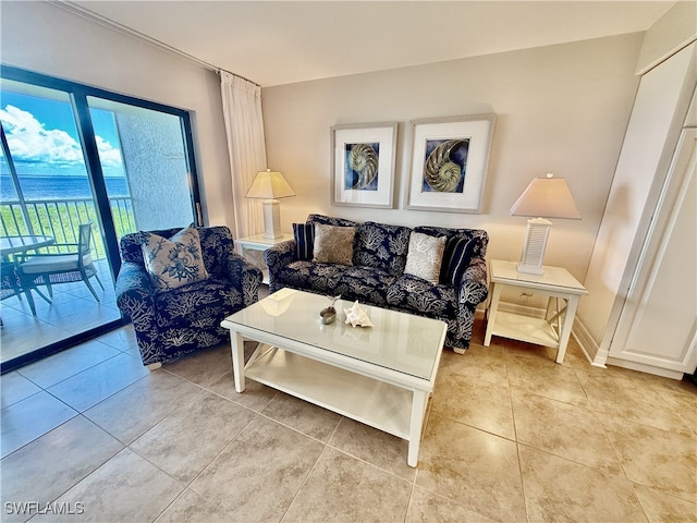 living room with light tile patterned floors and a water view