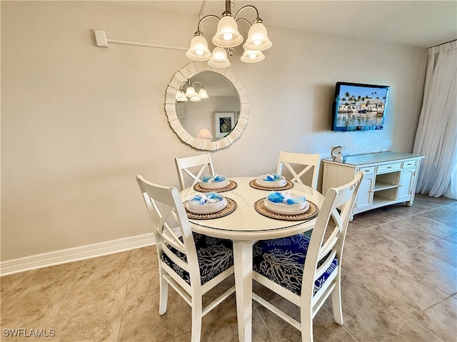 dining room with tile patterned floors and a chandelier