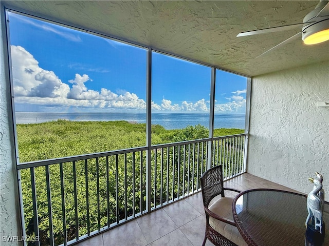 unfurnished sunroom featuring a water view