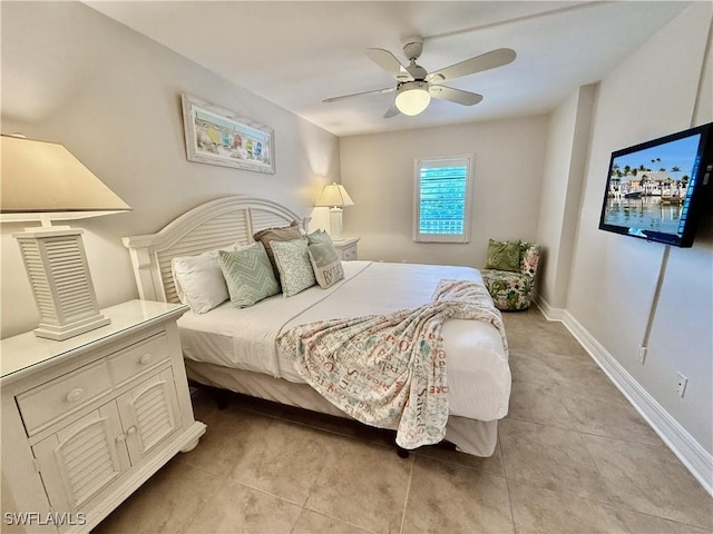 tiled bedroom featuring ceiling fan