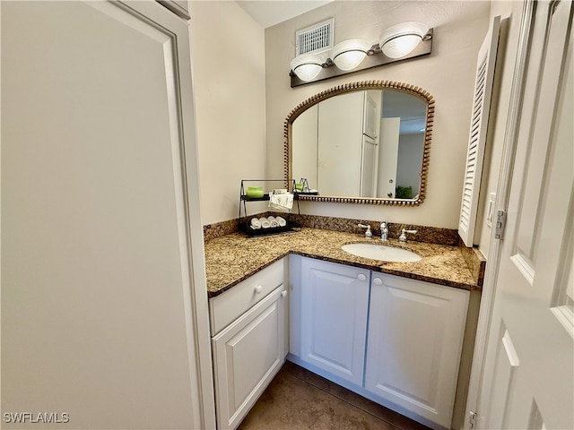 bathroom with tile patterned floors and vanity