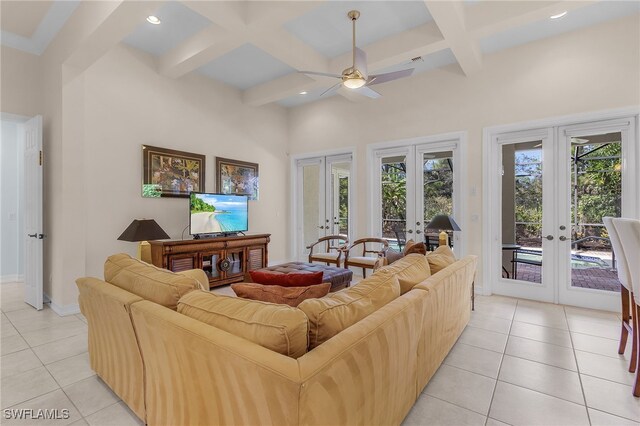 living room with light tile patterned floors, ceiling fan, beamed ceiling, and french doors