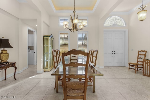 dining area with ornamental molding, light tile patterned flooring, a raised ceiling, and a chandelier