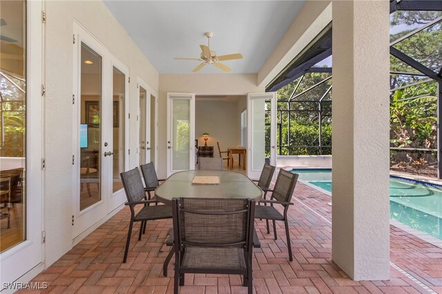 exterior space with ceiling fan, a pool, french doors, and a healthy amount of sunlight