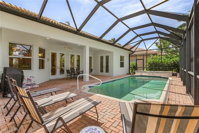 pool with a patio area, french doors, and a ceiling fan