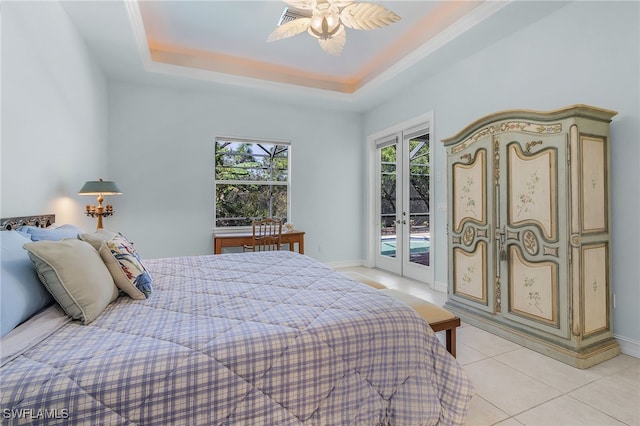 bedroom with access to outside, ceiling fan, light tile patterned floors, french doors, and a tray ceiling