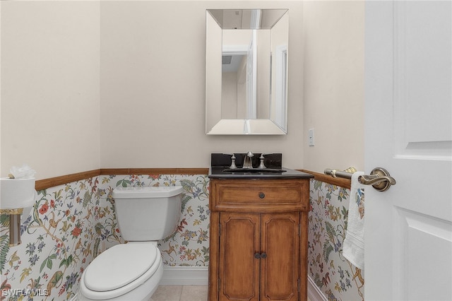 bathroom featuring vanity, toilet, and tile patterned floors