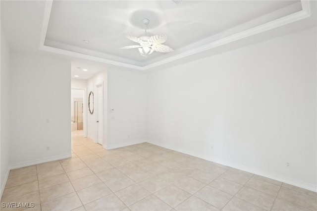 unfurnished room featuring a raised ceiling, light tile patterned floors, recessed lighting, baseboards, and ceiling fan