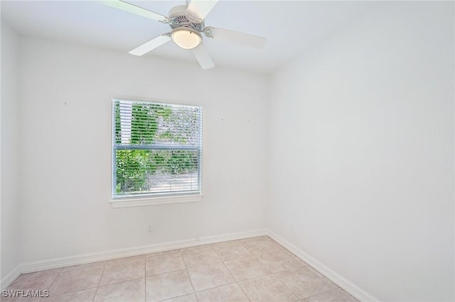 spare room with light tile patterned floors, baseboards, and ceiling fan