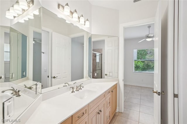 full bath featuring tile patterned flooring, a shower stall, ceiling fan, vanity, and baseboards