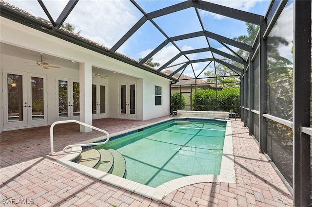 swimming pool with french doors, a patio area, and ceiling fan