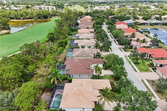 aerial perspective of suburban area with a golf course and a large body of water