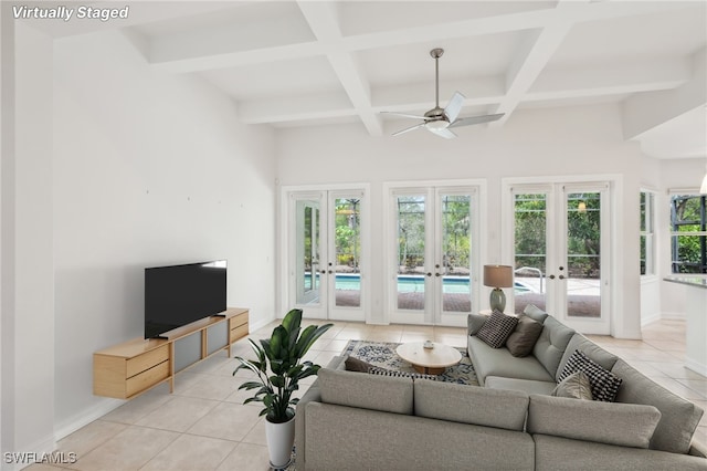 living room with french doors, light tile patterned floors, coffered ceiling, beam ceiling, and a ceiling fan