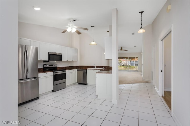 kitchen with stainless steel appliances, light tile patterned flooring, white cabinetry, and kitchen peninsula