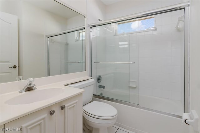 full bathroom featuring enclosed tub / shower combo, vanity, and toilet