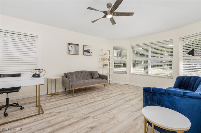 living area with light hardwood / wood-style floors and ceiling fan