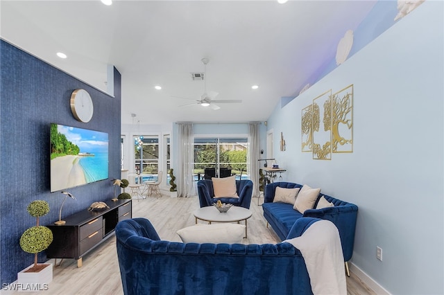 living room with ceiling fan and light wood-type flooring