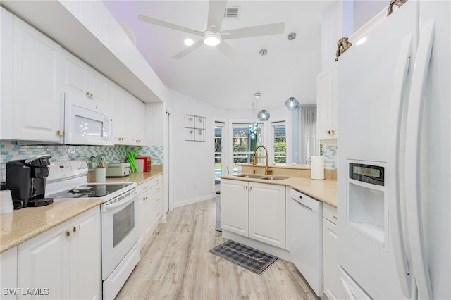 kitchen with pendant lighting, white cabinets, white appliances, and sink