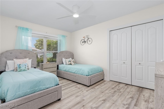 bedroom featuring ceiling fan, light hardwood / wood-style flooring, and a closet