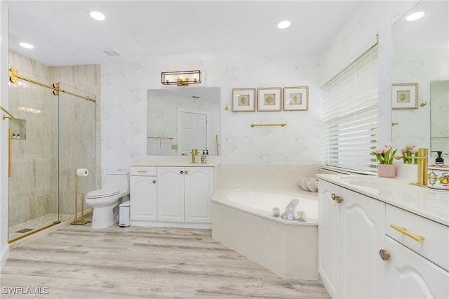 full bathroom featuring independent shower and bath, vanity, toilet, and hardwood / wood-style flooring