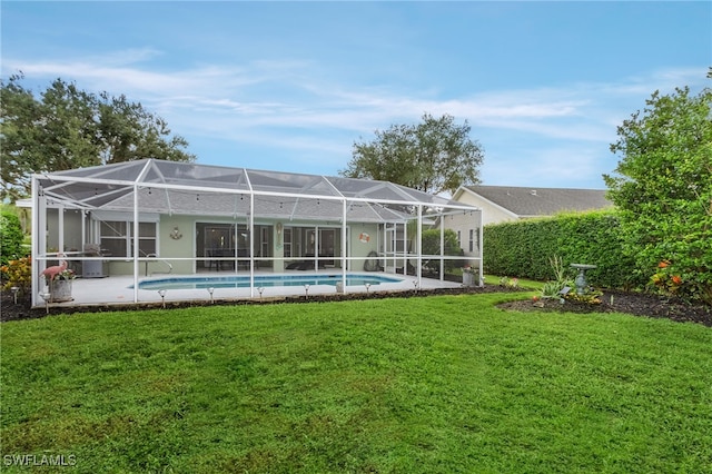 back of house featuring a yard, a lanai, and a patio area