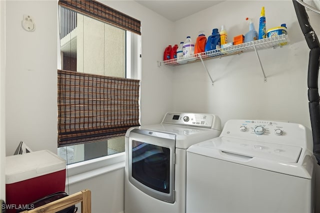 clothes washing area with washing machine and clothes dryer