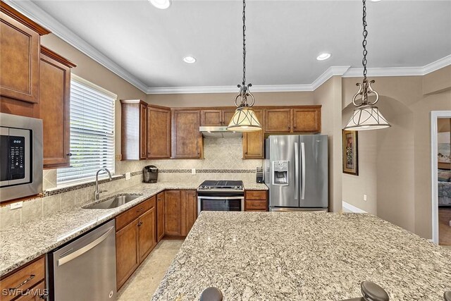 7638 Jacaranda Ln, Naples, FL 34114 - kitchen featuring a sink, light stone countertops, brown cabinetry, under cabinet range hood, and stainless steel appliances