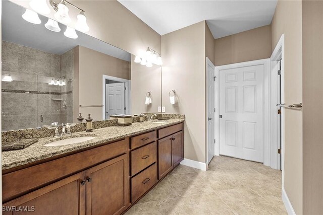 7638 Jacaranda Ln, Naples, FL 34114 - bathroom with a stall shower, double vanity, tile patterned flooring, and a sink