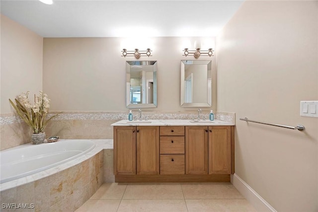 bathroom with tile patterned flooring, vanity, and tiled tub