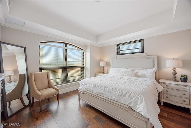 bedroom with crown molding, dark hardwood / wood-style flooring, a raised ceiling, and multiple windows