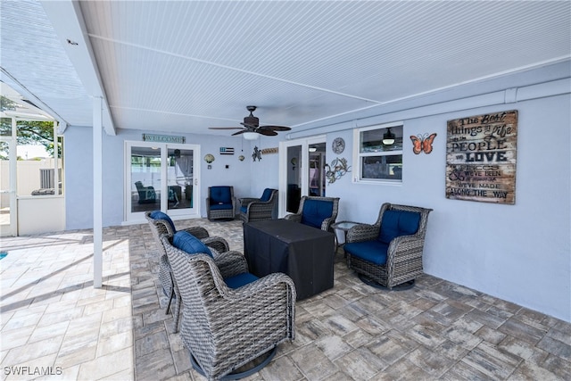 view of patio / terrace featuring an outdoor living space, ceiling fan, and french doors