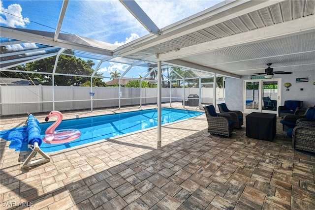 view of swimming pool featuring a lanai, a patio, and ceiling fan